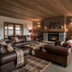 a living room with two couches and a fire place in the middle of it