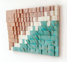 a wall sculpture made out of wooden blocks