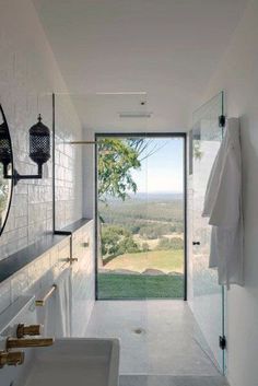 a white bathroom with a large glass door