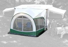 a tent is set up in the grass with two people near it and one person sitting on a chair