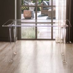 a clear table with two legs on the floor