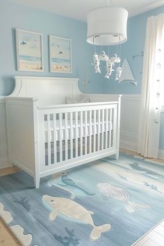 a baby's room with blue walls and white furniture