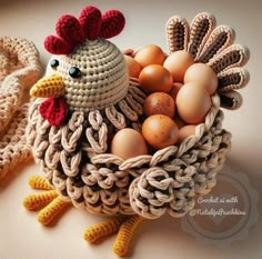 a crocheted chicken with eggs in it's nest on a table top