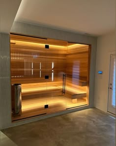 an empty room with a sauna in the middle