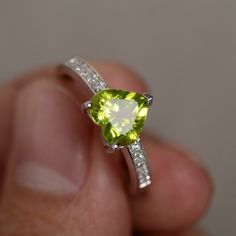 This is a gorgeous handmade creation. Its beauty is its simplicity & Elegance. The 8 mm heart cut faceted natural Peridot is crafted in solid sterling silver and with rhodium plated. Peridot is August birthstone. All item is sent in a beautiful gift box You can realize more lovely stuff clicking the link https://www.etsy.com/shop/knightjewelry?refshopsection_shophome_leftnav Please leave the correct address and you phone number for delivering successfully. Luxury Peridot Gemstones For Engagement, Luxury Green Birthstone Ring For Promise, Green Gemstone Engagement Rings, Engagement Rings Green, Peridot Rings, Etsy Engagement Rings, August Birthstone Ring, Vintage Engagement Rings Sapphire, Green Gemstone Ring