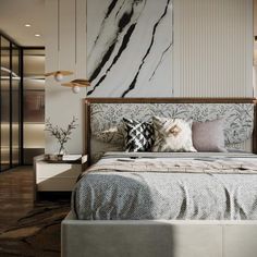 a bedroom with marble walls and white bedding, pillows and throw pillows on the headboard