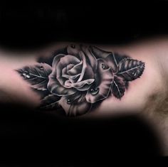 a black and white rose tattoo on the chest