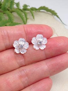 925 Sterling Silver Cz Mother of Pearl Flower Stud Earrings - Metal: 925 Sterling Silver (Finish: Rhodium Plated) - Stone: Lab-Created White Mother of Pearl, Clear Cubic Zirconia - Shape: Flower - Dimension: 11mm(0.43 in), Thickness 1.5mm/3mm (Thickness 3mm including center Cz stone). Cz Stone 2.8mm x 1.5mm. (Please note that the flower is 11mm, SMALL.) - Closure: Push Back (Post at center) - Color: Silver Diamond White Flower Earrings For Anniversary, Sterling Silver Flower Earrings For Anniversary And Mother's Day, White Sterling Silver Earrings For Mother's Day, Delicate Sterling Silver Jewelry With 3d Flowers, Sterling Silver Jewelry With 3d Flowers, Sterling Silver Jewelry With 3d Flower Design, Silver Diamond Flower Earrings, White Diamond Flower Earrings Fine Jewelry, Silver Flower Earrings For Mother's Day Anniversary