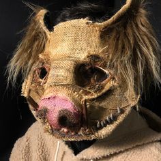 an animal mask with hair on it's head and nose is shown in front of a black background