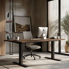 an office desk with two laptops on it and a plant in the corner next to it