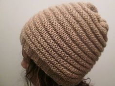 a woman wearing a brown knitted hat