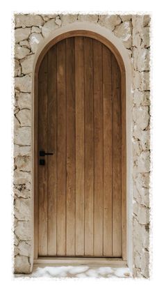 an arched wooden door on a stone wall