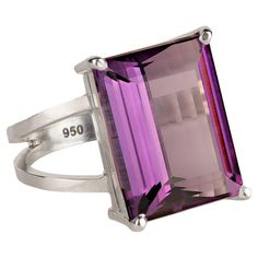 Exciting emerald cut 12Ct Amethyst and Sterling Silver ring. This 16x12MM gemstone is set in a custom made Sterling Silver setting and the entire package comes from our favorite vendor in Belo Horizonte, Minas Gerais, Brasil. Amethyst is the February birthstone and is said to protect from intoxication and evil spells. It will calm your spirit and give you focus. Pure quartz is colorless, but the most prized variety is Amethyst, the purple variety. It's always been considered a 'royal color' and is featured in the British Crown jewels. It was also a favorite of Catherine the Great and Egyptian royalty. For centuries this beautiful gemstone has been considered a symbol of power. This is a sizable 7.75 and can be sized by your local jeweler. No changes by seller. MR2308 Luxury Silver Cubic Zirconia Amethyst Ring, Luxury Silver Amethyst Ring In Modern Style, Luxury Amethyst Rectangular Stone Ring For Gift, Egyptian Royalty, British Crown Jewels, Amethyst Set, Basket Style, Catherine The Great, Handmade Sterling Silver Rings