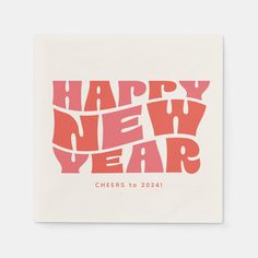 a napkin with the words happy new year written in pink and red on white paper