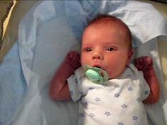 a baby laying down with a pacifier in its mouth