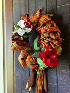 a colorful wreath hanging on the side of a door