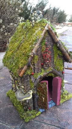 a small house made out of moss and rocks