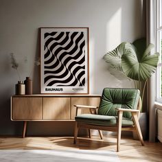 a green chair sitting in front of a window next to a wooden cabinet and potted plant