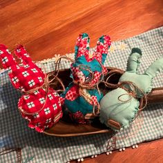 an old wooden sled filled with stuffed animals on top of a blue and white checkered table cloth