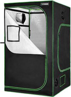 a black and green grow tent with the door open