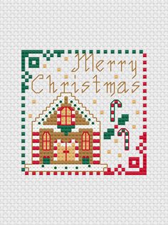 a cross stitch christmas card with a gingerbread house