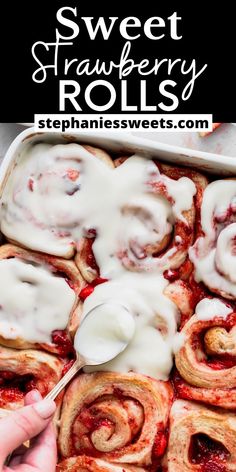 a pan filled with cinnamon rolls covered in white icing and drizzled