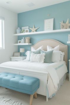 a bedroom with blue walls and white bedding, two shelves on either side of the bed