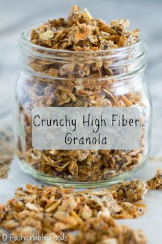 a glass jar filled with granola sitting on top of a table