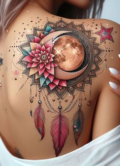 the back of a woman's shoulder with tattoos on it and a moon in the middle