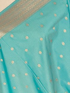 Beautiful Pastel Sea Blue Handmade Dupatta with Koniya design and small buttis all over the dupatta. Super Light weight and very easy to carry. Can be worn with a Suit or lehenga easily. Item: DupattaBase color : Sea Blue Zari Work : Muted Gold Fabric : Premium quality Banarasi Soft SilkWork : Zari Weaved with tasselsLength of the dupatta : 92 inches Width of the dupatta : 37 inches Store Policies - No return or exchange will be accepted for color variations. - No return or exchange will be acce Blue Chanderi Pre-draped Saree With Motifs, Light Blue Semi-stitched Dupatta For Navratri, Light Blue Traditional Drape Set With Dupatta, Traditional Light Blue Set With Dupatta, Festive Turquoise Pre-draped Saree, Festive Light Blue Sets With Traditional Drape, Festive Light Blue Set With Traditional Drape, Traditional Turquoise Lehenga With Unstitched Blouse, Blue Anarkali Banarasi Silk Sets