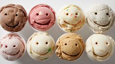 six different colored cupcakes with faces on them