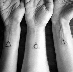 two people with matching tattoos on their arms