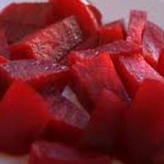 sliced up red vegetables on a white plate