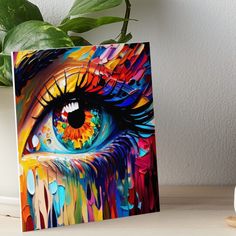 an eye with colorful paint on it art board print