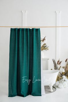 a bath tub sitting next to a green curtain