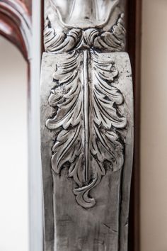 an ornate metal door handle on a wooden door