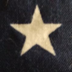 a white star sitting on top of a black cloth