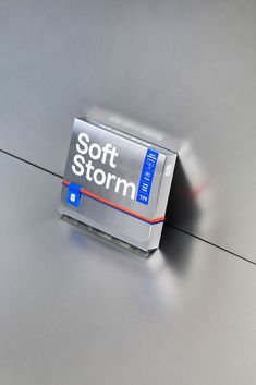 an electronic device sitting on top of a metal surface with the words soft storm printed on it