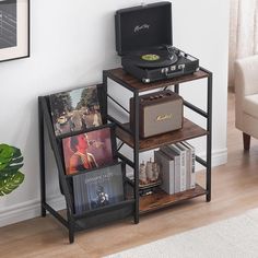 a record player is sitting on top of a shelf with books and cds in it