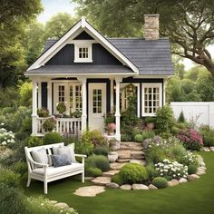 a small white house sitting on top of a lush green field