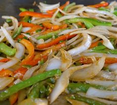 stir fried vegetables are being prepared in a wok