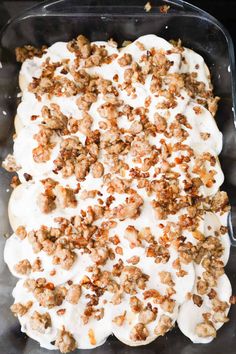 a casserole dish with cream cheese and walnuts on top is ready to be eaten