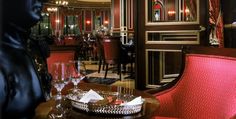 a fancy restaurant with red upholstered chairs