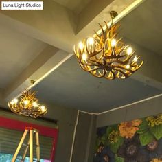 a chandelier hanging from the ceiling in a room with flowers painted on it