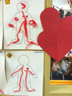 children's drawings are displayed on the wall in front of their classroom door, with paper cut out to look like human figures