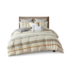 an image of a bed with pillows and comforter set on top of the bed