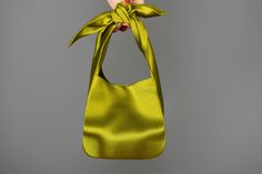 🔘 This Elegant Satin knot bag is ideal for the wedding day, night out, party, special occasion, brides, bridesmaids, mothers of the bride, or any formal fun 🔘 This  bag has an elastic opening and a stiff bottom   🔘 Please contact us for a custom order. 🔘 Material: Satin fabric or faux Silk. The lining fabric is the same fabric as on the outside. This bag has a magnetic snap closure inside. It also has a bottom shaper inside. 🔘 Measurements: Bottom Length x Height x Depth; 16 x 16 x 10 cm / 6,3'' x 6,3'' x 4'' 🔘 Care instruction: Hand wash in luke water. Furoshiki Bag, Yellow Clutch, Japanese Knot, Satin Purses, Green Chartreuse, Japanese Knot Bag, Knot Bag, Silk Bag, Yellow Satin