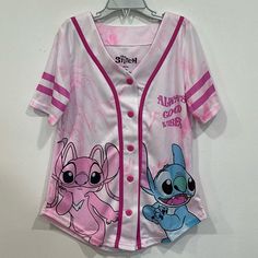 For Sale Is A Brand New Without Tags Disney Angel & Stitch Kids Baseball Jersey In Size 7/8. This Pink & White Tie Dye Jersey Features Stitch And Angel From The Disney Franchise Lilo & Stitch On Both The Front And Back. On The Chest, It Says Always Good Vibes. There Are Stripes On The Sleeves. Comes From A Smoke Free And Pet Free Home. Cartoon Print Tops For Sleepover In Spring, Spring Cartoon Print Tops For Sleepover, Themed Short Sleeve Tops For Playtime, Cartoon Print Tops For Spring Sleepover, Pink Cartoon Print Top For Disney Fan Events, Themed Pink Tops With Letter Print, White Character Print Top For Sleepovers, Fun White Tops For Sleepover, Playful Pink Top For Disney Fan Events