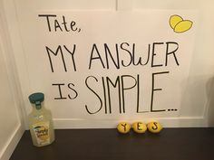 a sign that says tate, my answer is simple and two lemons are next to it