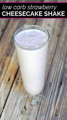 low carb strawberry cheesecake shake in a glass on a wooden table with text overlay